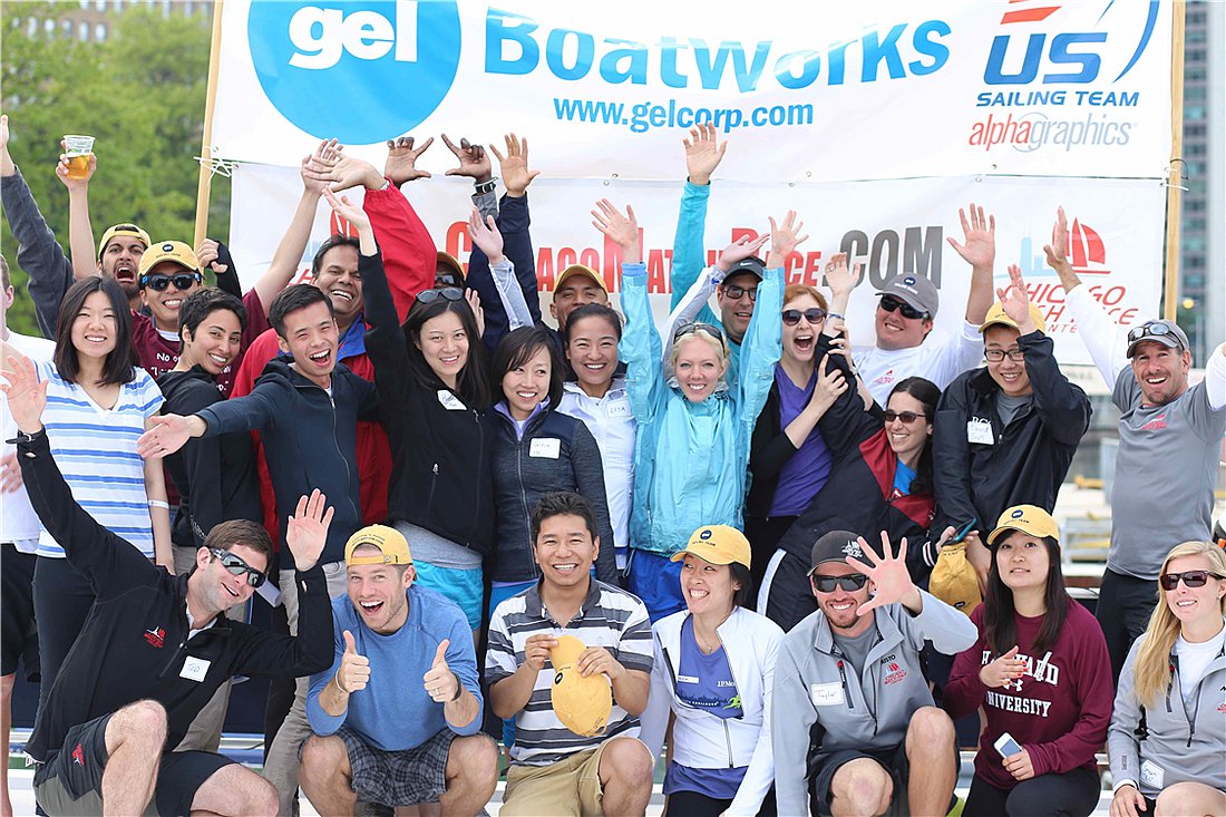 Group cheering in front of BoatWorks banner